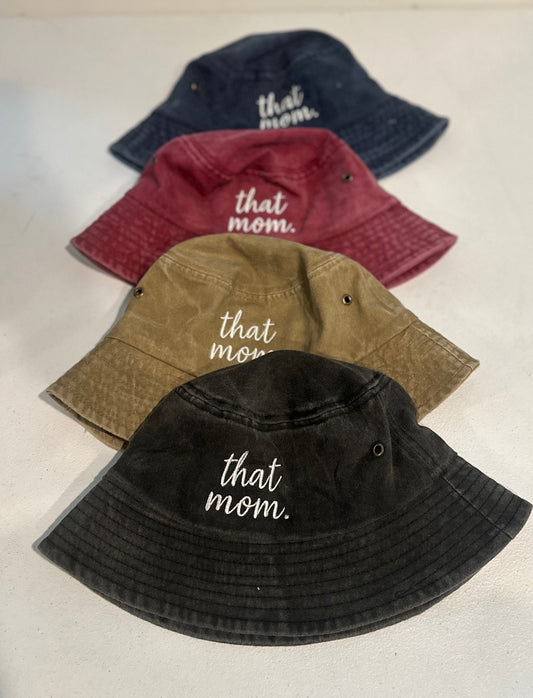 Four bucket hats in different colors with 'that mom' text on a light background